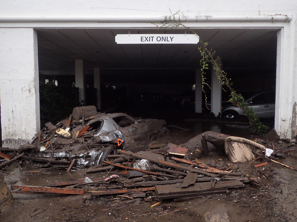 <div class='meta'><div class='origin-logo' data-origin='none'></div><span class='caption-text' data-credit='@EliasonMike/Twitter'>"Damaged vehicles carried by mud flow and debris at the exit of the parking garage to The Montecito Inn at the corner of Olive Mill and Coast Village Road."</span></div>