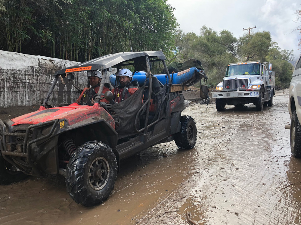 <div class='meta'><div class='origin-logo' data-origin='none'></div><span class='caption-text' data-credit='Santa Barbara County Fire'>"SB Sheriff’s Search and Rescue personnel along with Santa Barbara County Firefighters drive on Olive Mill Road in Montecito."</span></div>