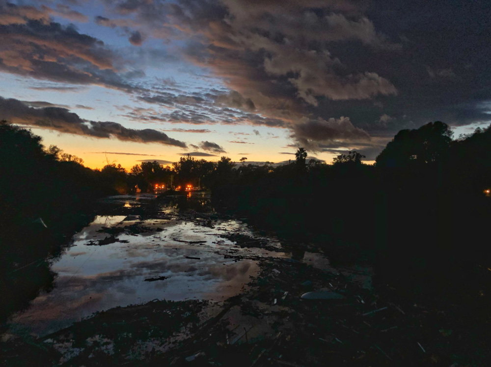 <div class='meta'><div class='origin-logo' data-origin='none'></div><span class='caption-text' data-credit='Santa Barbara County Fire'>"The sun sets behind US 101 Freeway at the Olive Mill Road overpass which remains flooded with runoff water from Montecito Creek."</span></div>