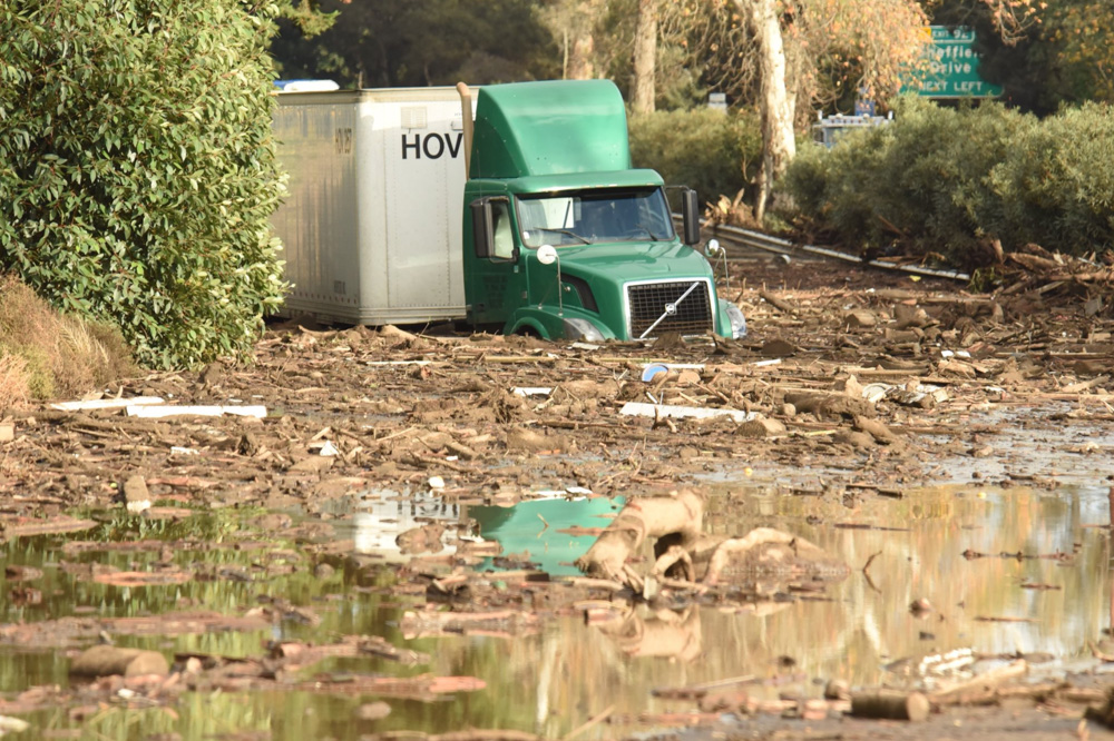<div class='meta'><div class='origin-logo' data-origin='none'></div><span class='caption-text' data-credit='Santa Barbara County Fire'>"A semi-tractor trailer  sits stuck in mud on US Highway 101 northbound just south of the San Ysidro Road offramp in Montecito."</span></div>