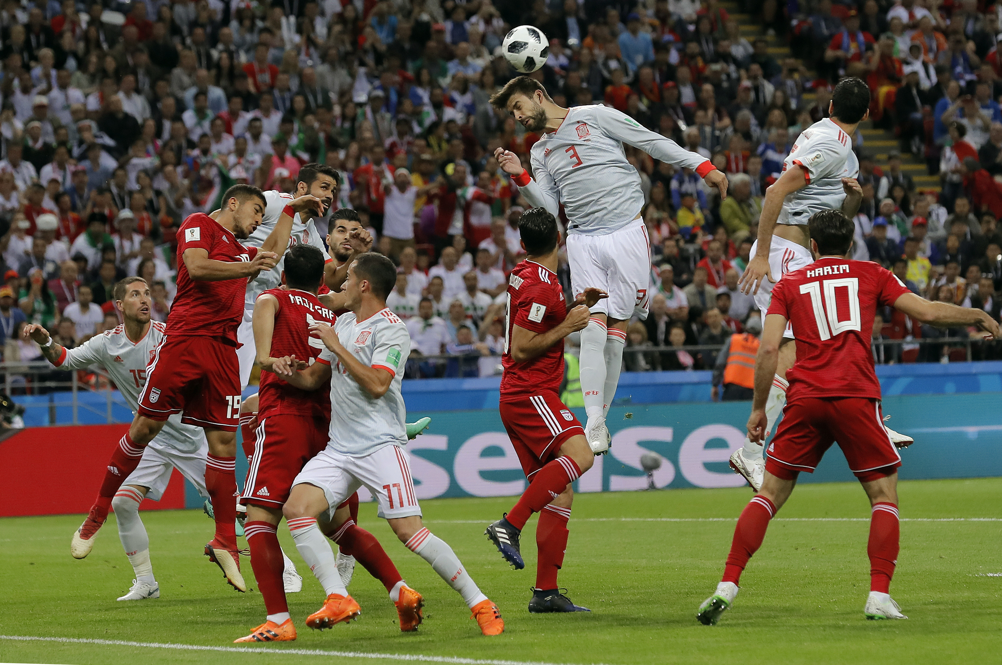 <div class='meta'><div class='origin-logo' data-origin='none'></div><span class='caption-text' data-credit='Manu Fernandez/AP Photo'>Spain's Gerard Pique, center, jumps for a header during the group B match between Iran and Spain at the 2018 soccer World Cup in the Kazan Arena in Kazan, Russia on June 20, 2018.</span></div>
