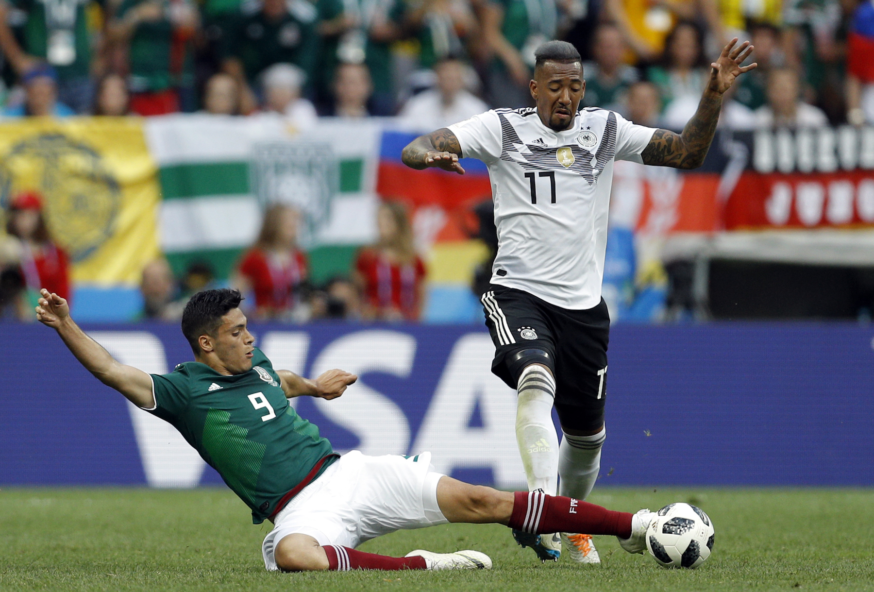 <div class='meta'><div class='origin-logo' data-origin='AP'></div><span class='caption-text' data-credit='AP Photo/Victor R. Caivano'>Mexico's Raul Jimenez, left, tackles Germany's Jerome Boateng during the group F match between Germany and Mexico at the 2018 soccer World Cup in the Luzhniki Stadium.</span></div>
