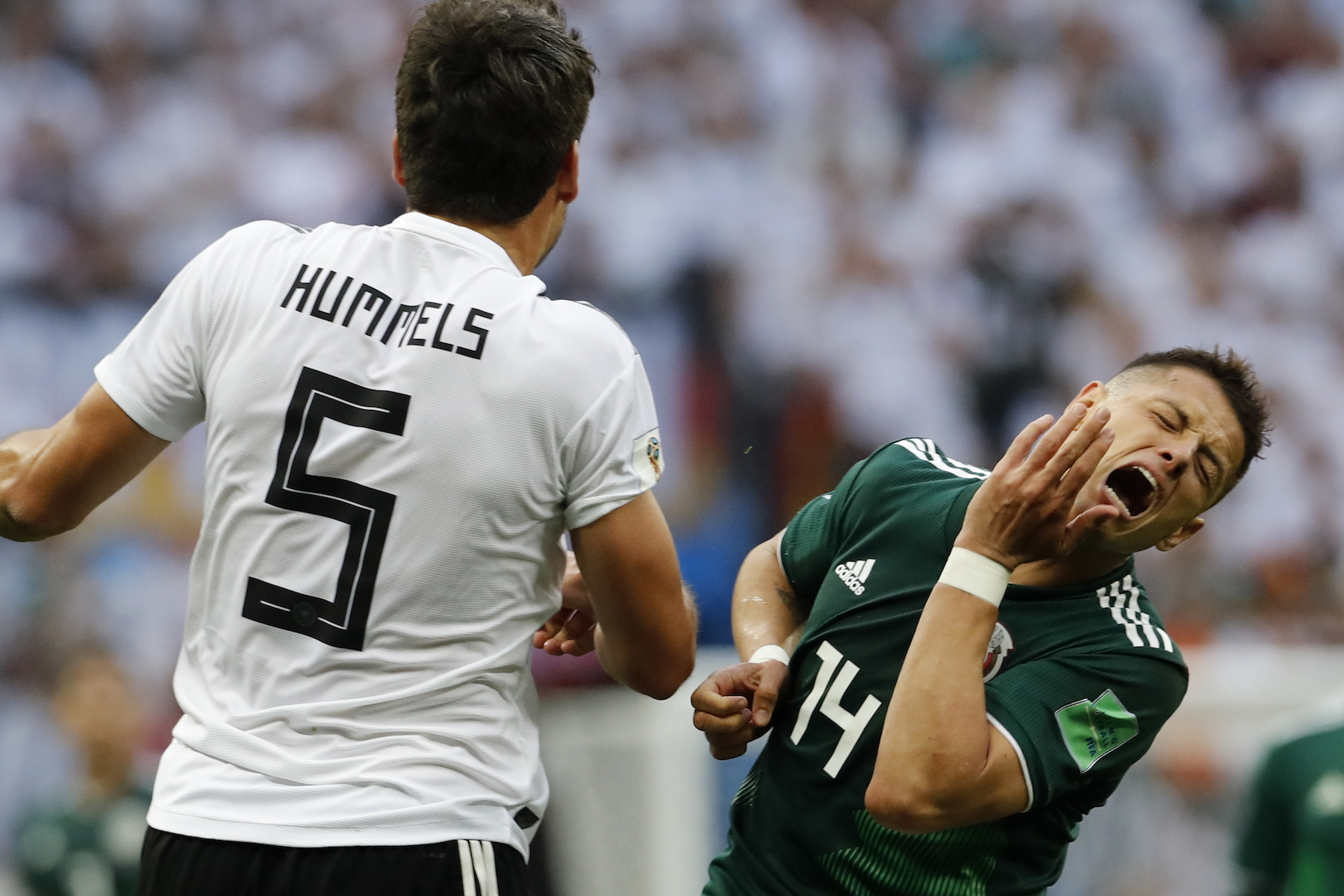 <div class='meta'><div class='origin-logo' data-origin='AP'></div><span class='caption-text' data-credit='AP Photo/Antonio Calanni'>Mexico's Javier Hernandez, right, gestures as competes for the ball with Germany's Mats Hummels during the group F match between Germany and Mexico at the 2018 soccer World Cup.</span></div>