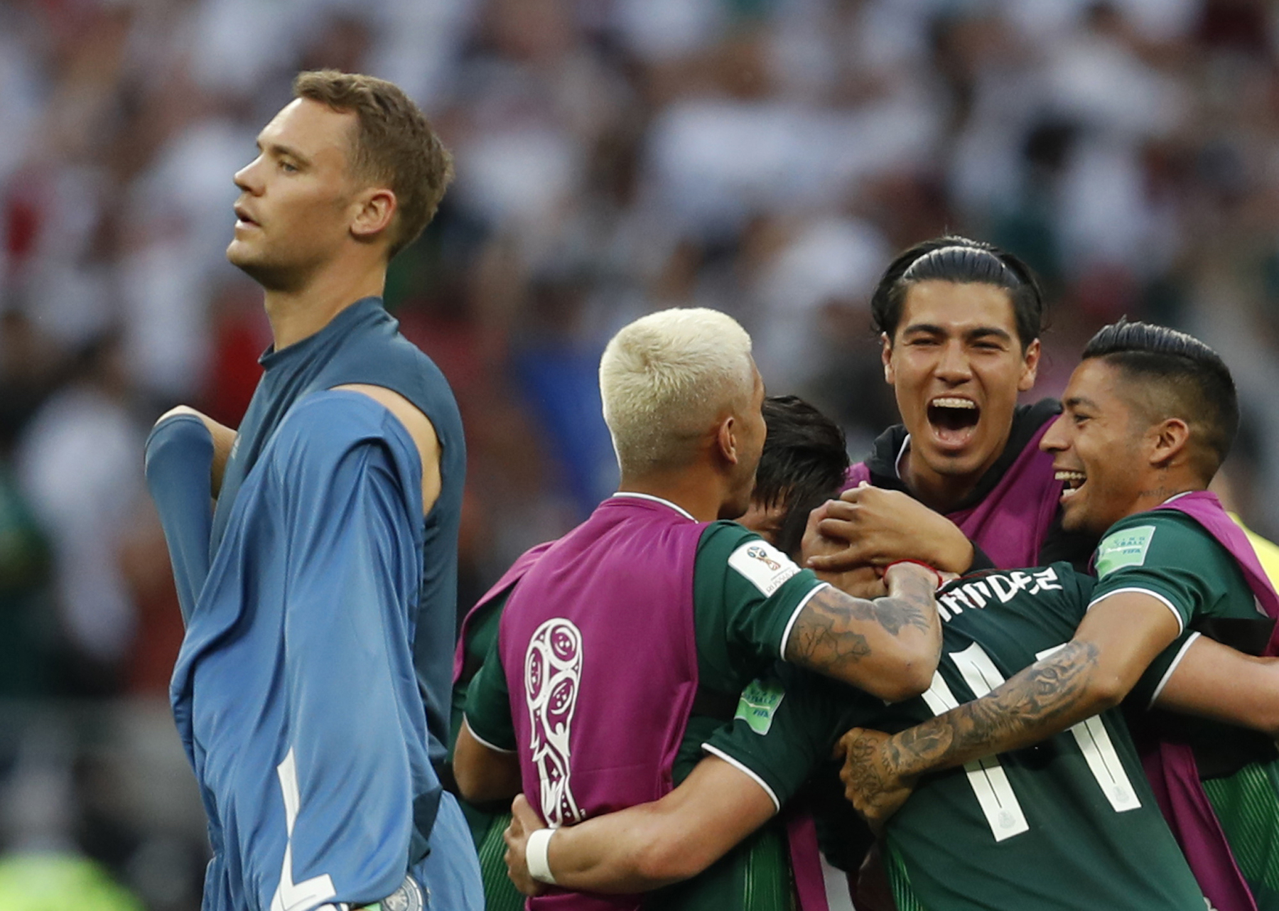 <div class='meta'><div class='origin-logo' data-origin='AP'></div><span class='caption-text' data-credit='AP Photo/Eduardo Verdugo'>Germany goalkeeper Manuel Neuer walks past as Mexico players celebrate after defeating Germany 1-0 in their group F match at the 2018 soccer World Cup.</span></div>