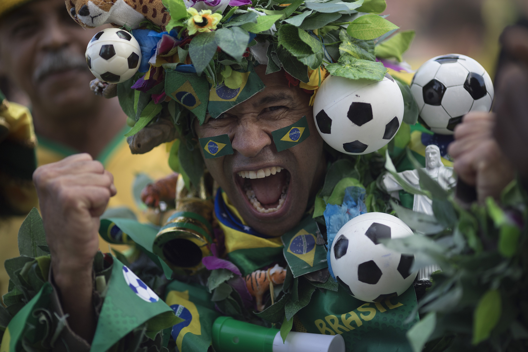 <div class='meta'><div class='origin-logo' data-origin='AP'></div><span class='caption-text' data-credit='AP Photo/Leo Correa'>A Brazil soccer fan, in a costume, poses to the camera as he cheers before his team's World Cup match against Switzerland in Rio de Janeiro, Brazil, Sunday, June 17, 2018.</span></div>