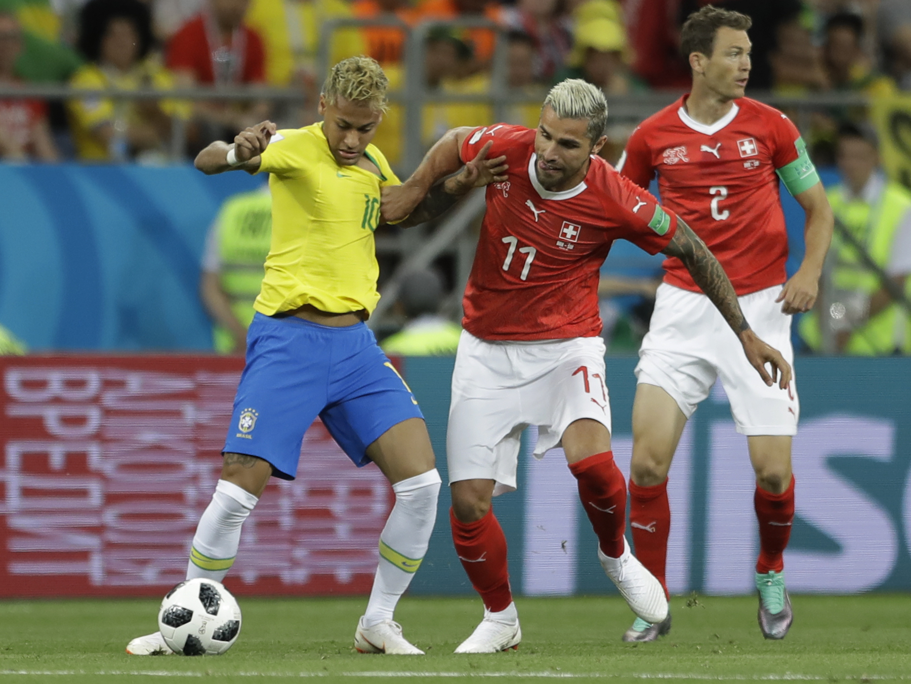 <div class='meta'><div class='origin-logo' data-origin='AP'></div><span class='caption-text' data-credit='AP Photo/Andre Penner'>Brazil's Neymar, left, is challenged for the ball by Switzerland's Valon Behrami during the group E match between Brazil and Switzerland at the 2018 soccer World Cup.</span></div>