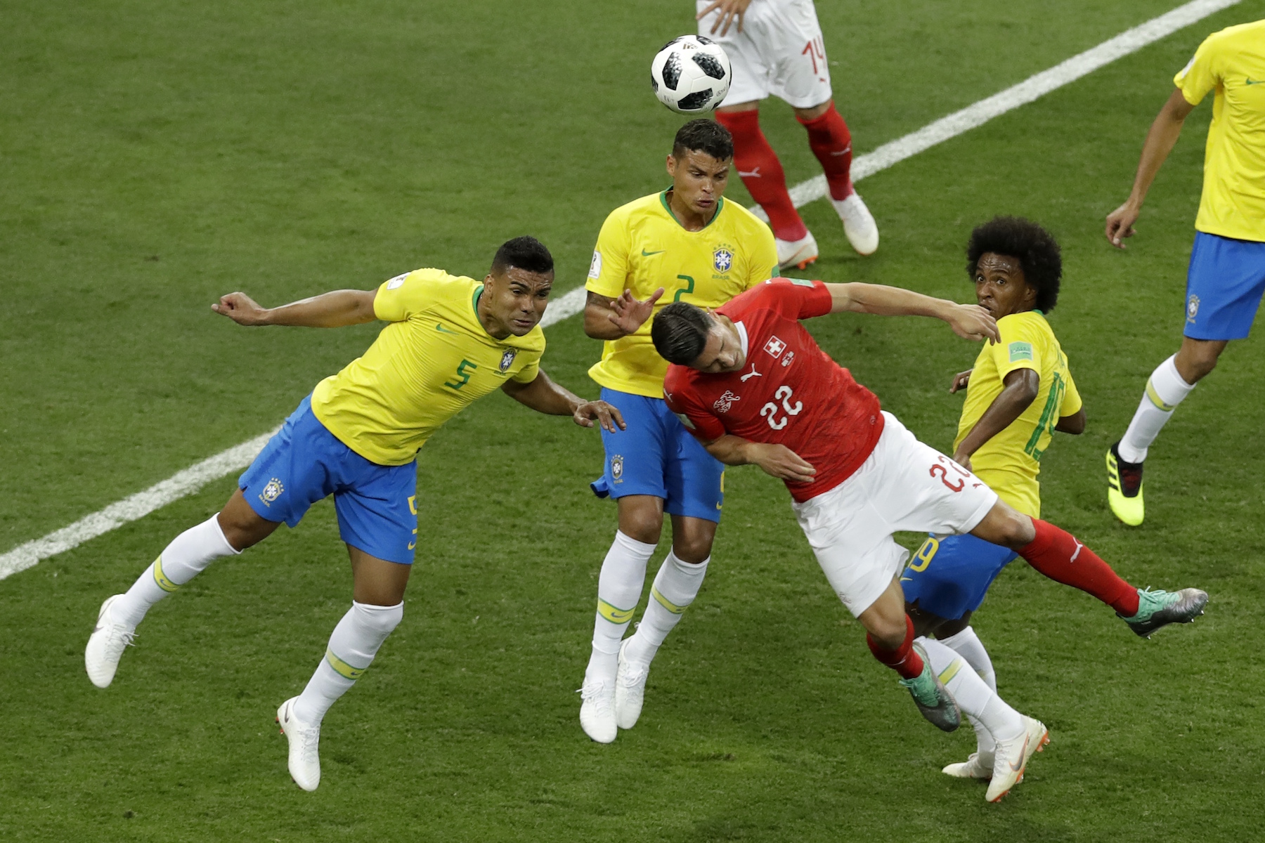 <div class='meta'><div class='origin-logo' data-origin='AP'></div><span class='caption-text' data-credit='AP Photo/Andrew Medichini'>Brazil's Casemiro, left, Thiago Silvaand, center, and Switzerland's Fabian Schaer jump for the ball during the group E match between Brazil and Switzerland.</span></div>