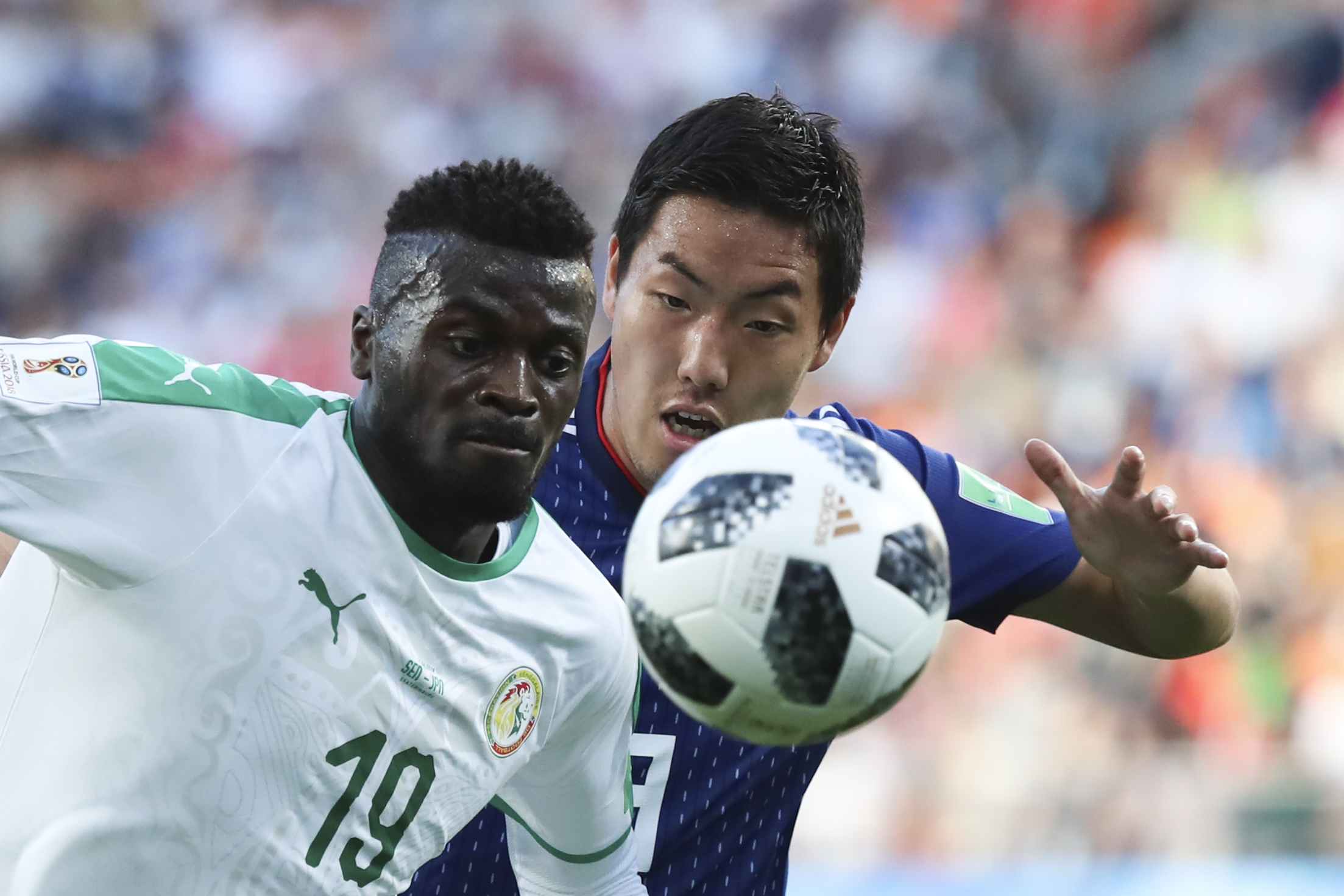 <div class='meta'><div class='origin-logo' data-origin='none'></div><span class='caption-text' data-credit='Eugene Hoshiko/AP Photo'>Senegal's Mbaye Niang, left, and Japan's Gen Shoji challenge for the ball during the group H match at the Yekaterinburg Arena in Yekaterinburg, Russia, Sunday, June 24, 2018.</span></div>