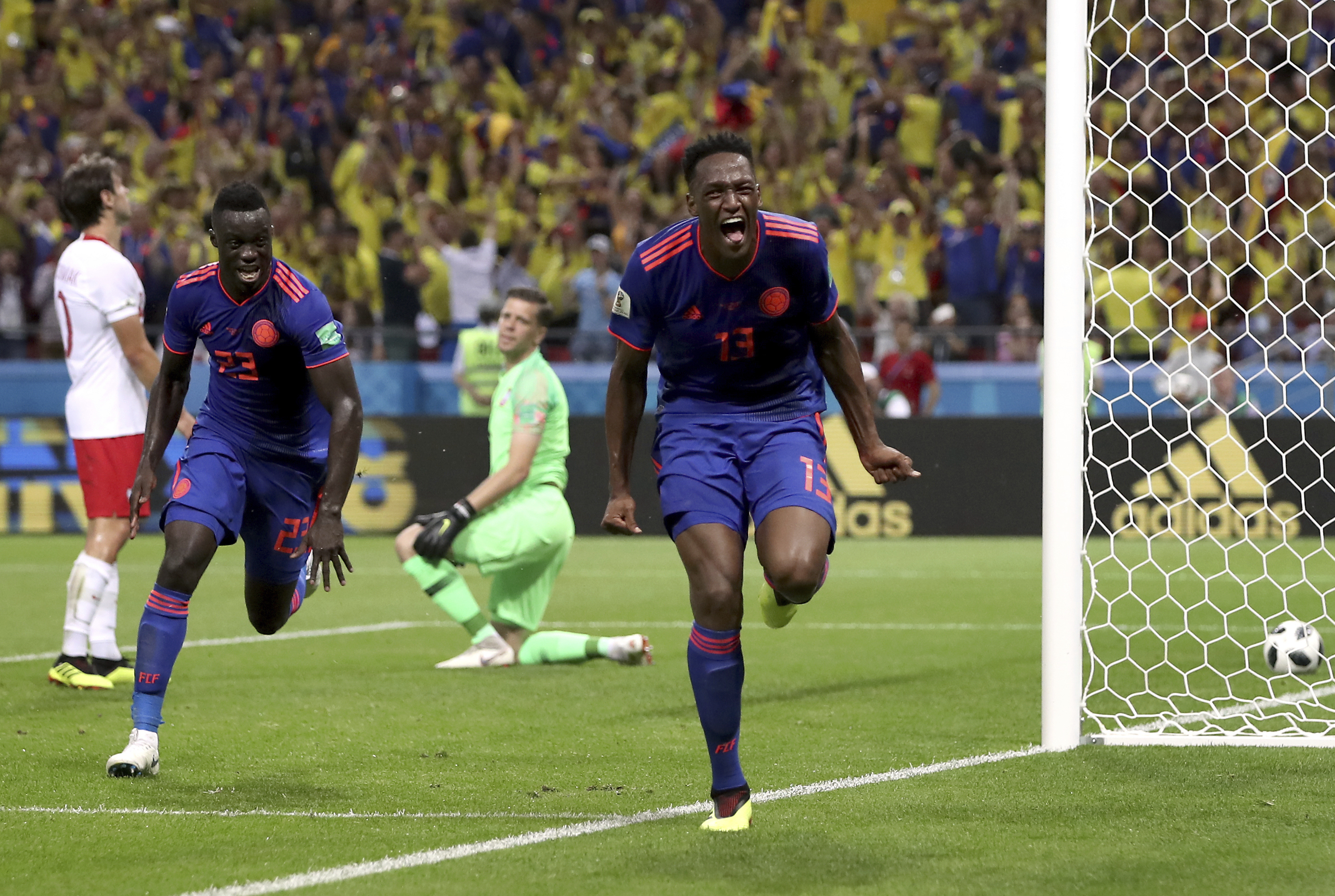 <div class='meta'><div class='origin-logo' data-origin='none'></div><span class='caption-text' data-credit='Thanassis Stavrakis/AP Photo'>Colombia's scorer Yerry Mina, right and his teammate Davinson Sanchez, left, celebrate the opening goal during the group H match against Poland at the Kazan Arena on June 24.</span></div>
