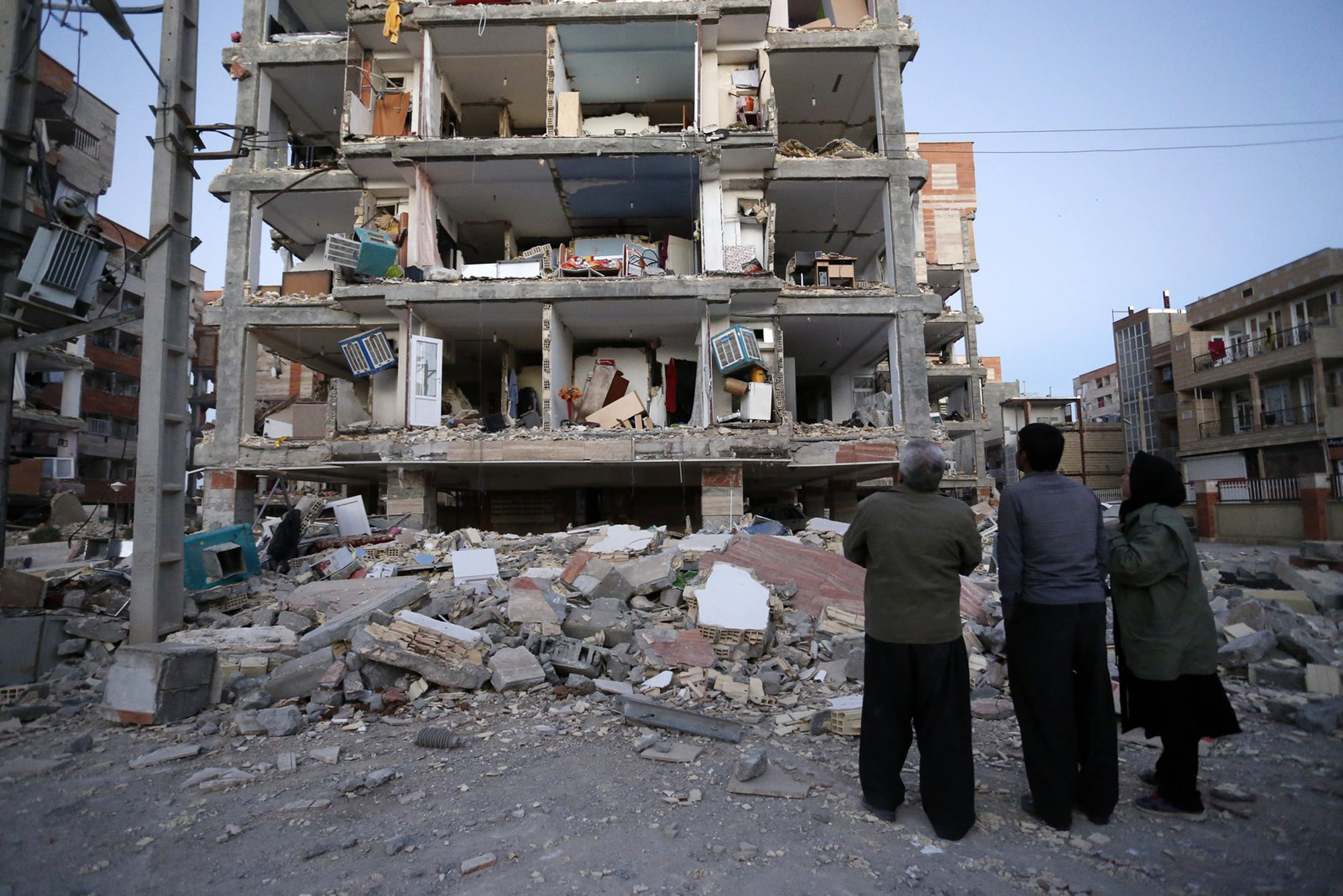 <div class='meta'><div class='origin-logo' data-origin='none'></div><span class='caption-text' data-credit='Pouria Pakizeh/ISNA via AP'>In this photo provided by the ISNA, people look at destroyed buildings after an earthquake at the city of Sarpol-e-Zahab in western Iran, Monday, Nov. 13, 2017.</span></div>
