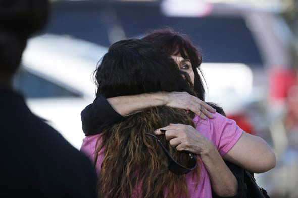 <div class='meta'><div class='origin-logo' data-origin='~ORIGIN~'></div><span class='caption-text' data-credit='AP Photo/ Jae C. Hong'>Teresa Hernandez, facing camera, is comforted by a woman as she arrives at a social services center in San Bernardino, Calif.</span></div>
