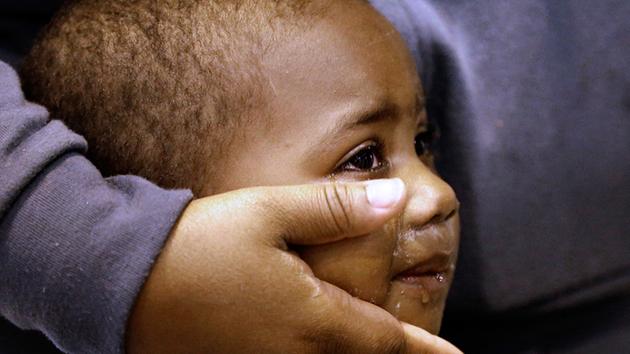 <div class='meta'><div class='origin-logo' data-origin='none'></div><span class='caption-text' data-credit='David J. Phillip/AP Photo'>Cyree Howard, 3, is comforted by his mother's hand while inside a shelter setup inside NRG Center for victims of Harvey Wednesday, Aug. 30, 2017, in Houston.</span></div>