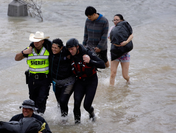 <div class='meta'><div class='origin-logo' data-origin='none'></div><span class='caption-text' data-credit='David J. Phillip/AP Photo'>A woman is helped by rescue personnel while being evacuated as floodwaters from Hurricane Harvey rise Monday, Aug. 28, 2017, in Houston.</span></div>