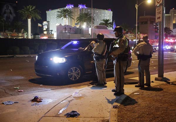 <div class='meta'><div class='origin-logo' data-origin='AP'></div><span class='caption-text' data-credit='AP'>Las Vegas Police stand at the scene of a shooting along the Las Vegas Strip, Monday, Oct. 2, 2017, in Las Vegas. (AP Photo/John Locher)</span></div>