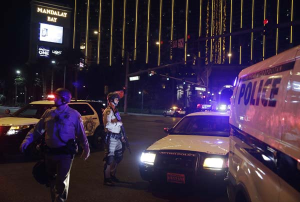 <div class='meta'><div class='origin-logo' data-origin='AP'></div><span class='caption-text' data-credit='AP'>Police officers stand along the Las Vegas Strip outside the Mandalay Bay resort and casino (AP Photo/John Locher)</span></div>