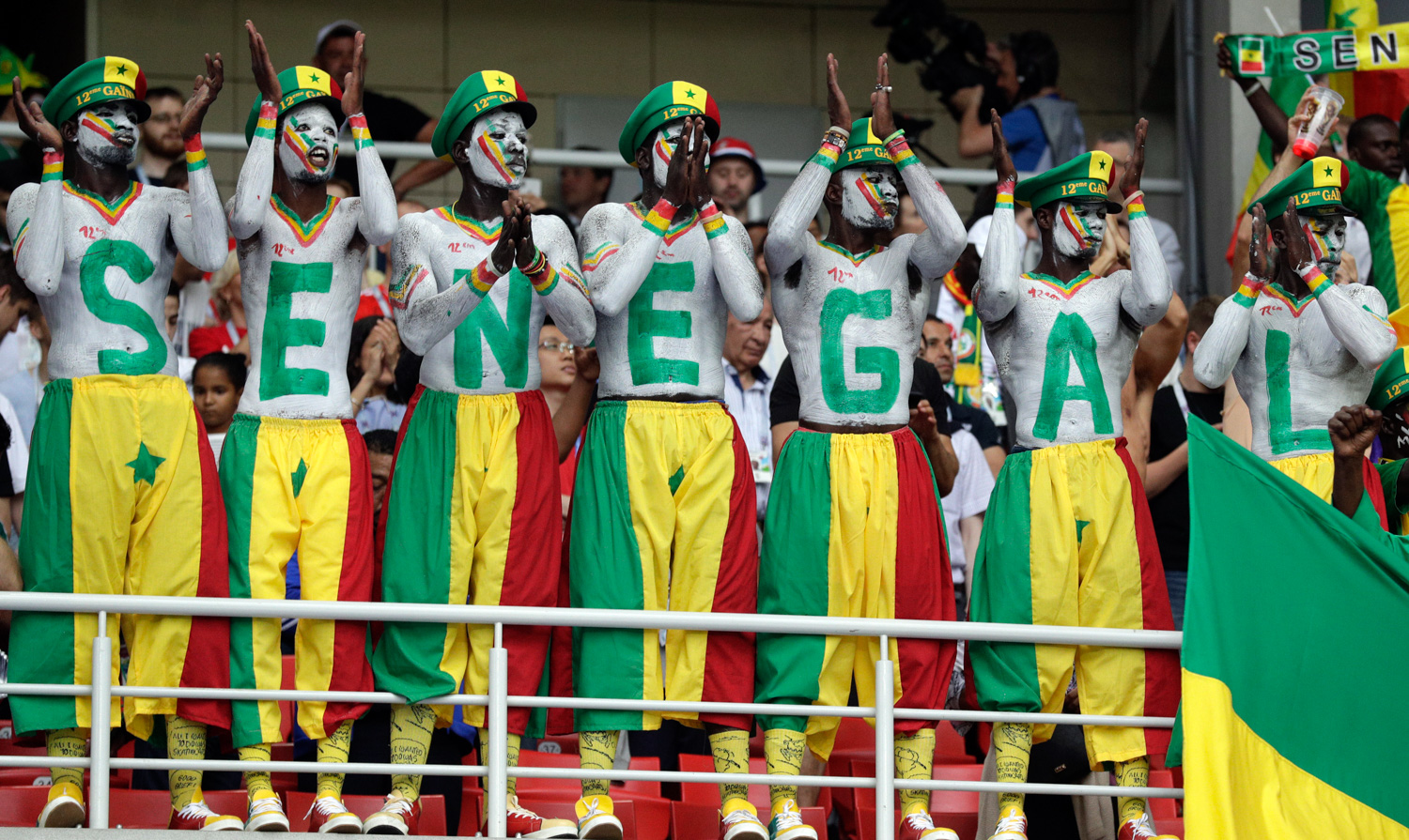 <div class='meta'><div class='origin-logo' data-origin='none'></div><span class='caption-text' data-credit='Andrew Medichini/AP'>Senegal's fans, their bodies and faces painted in the colors of the national flag, support their team during the group H match between Poland and Senegal</span></div>