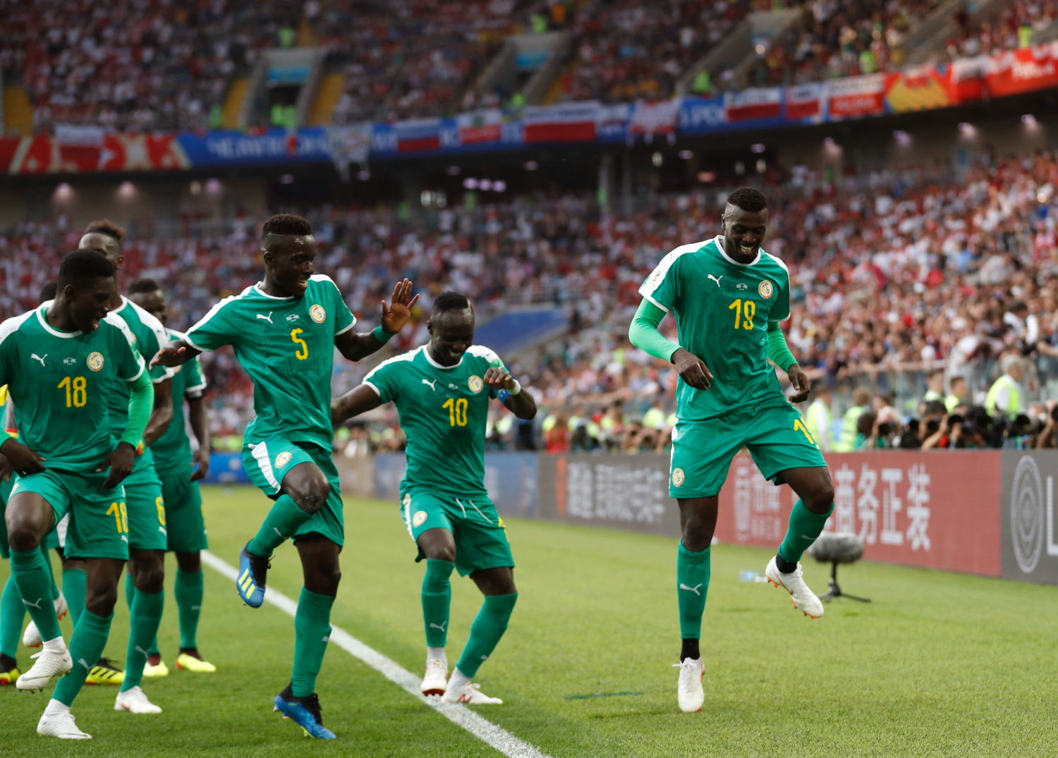 <div class='meta'><div class='origin-logo' data-origin='none'></div><span class='caption-text' data-credit='Eduardo Verdugo/AP'>Senegal's Mbaye Niang, right, dances in celebration with his teammates scoring his side's second goalduring the group H match between Poland and Senegal</span></div>