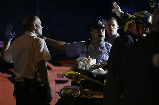 <div class='meta'><div class='origin-logo' data-origin='none'></div><span class='caption-text' data-credit='AP Photo/ Matt Slocum'>Emergency personnel transport a person at the scene of a train wreck, Tuesday, May 12, 2015, in Philadelphia.</span></div>