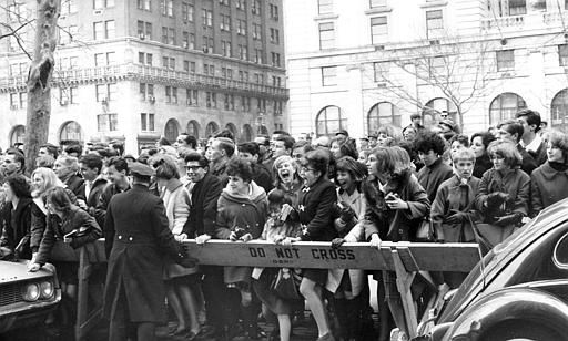 Police enforce the barricades outside New York's Plaza Hotel as fans push forward in hopes of a view of The Beatles after their arrival for an American tour in 1964. <span class=meta>AP Photo</span>