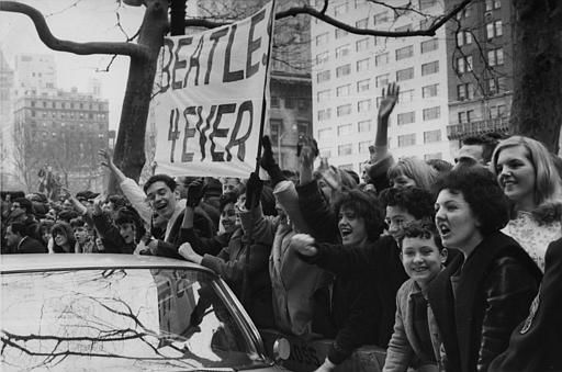 Screaming teenagers, mostly girls, wave a banner "Beatles forever" welcoming The Beatles, outside the Plaza Hotel in New York City, USA, February 7, 1964. <span class=meta>AP Photo</span>