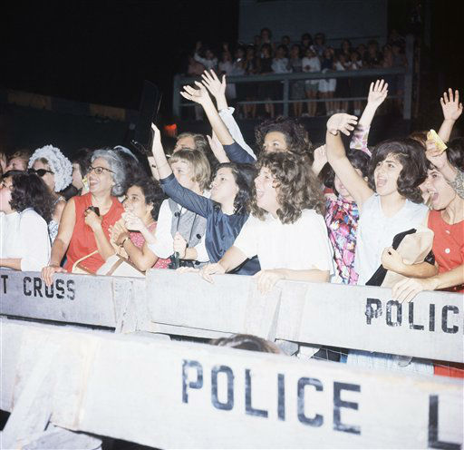 Fans of The Beatles scream from behind police barricades at New York's Kennedy Airport, Feb. 7, 1964. <span class=meta>AP Photo</span>