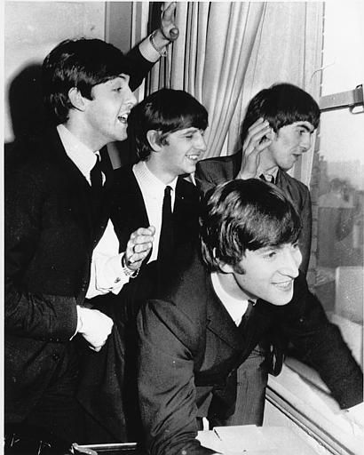 The Beatles wave to fans assembled below their Plaza Hotel window after they arrived in New York City on Feb. 7, 1964 for a short tour of the United States. <span class=meta>AP Photo</span>