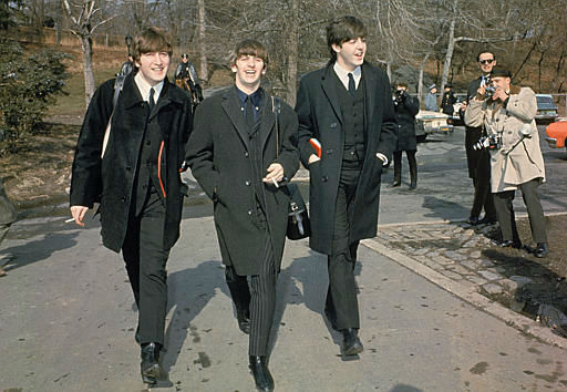 Three of the four Beatles, from left, John Lennon, Ringo Starr, and Paul McCartney, walk in Central Park in New York City, Feb. 10, 1964 on their first U.S. tour. <span class=meta>AP Photo</span>