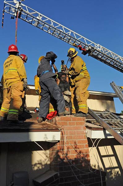USAR members hoist a woman from a chimney in Thousand Oaks on Sunday, Oct. 19, 2014. VCFD Capt. Mike Lindbery, Twitter.com/VCFD_PIO