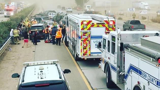 Firefighters and paramedics tend to people who suffered minor injuries in a multiple-car crash on Highway 99 near Bakersfield on Monday, Nov. 2, 2015.