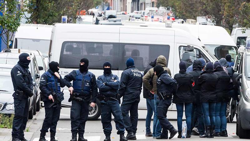 A major action with heavily armed police is underway Monday, Nov. 16, 2015 in the Brussels neighborhood of Molenbeek amid a manhunt for a suspect of the Paris attacks.