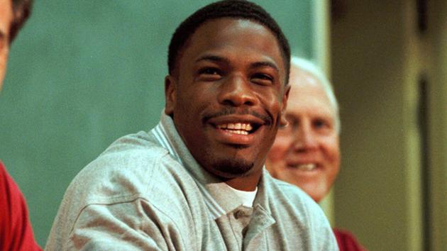 In this July 26, 1999, file photo, newly-signed San Francisco 49ers running back Lawrence Phillips, smiles during a news conference at training camp in Stockton, Calif. 