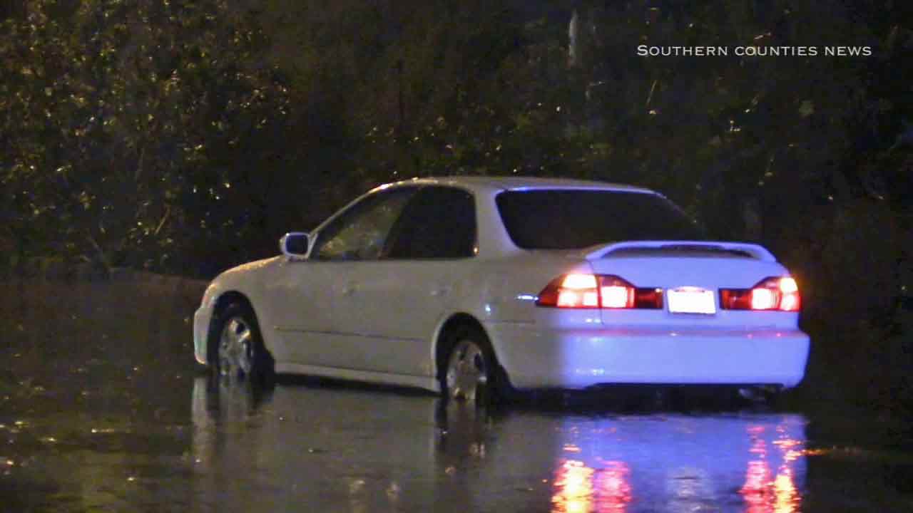 A car is seen driving through a flooded street after the storm on Friday, Dec. 12, 2014. <span class=meta></span>