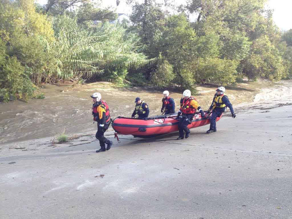 Reporter Rob Hayes shows the LAFD swift-water-rescue team grabbing a boat to save a man and woman trapped in the Los Angeles River on Friday, Dec. 12 2014. <span class=meta>Rob Hayes, ABC7</span>