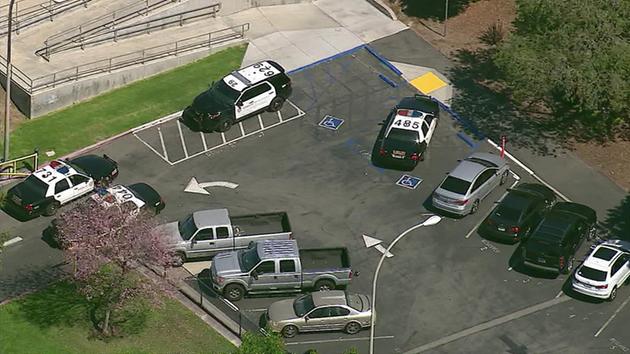 Law enforcement vehicles are parked outside Walnut High School on Thursday, March 24, 2016.