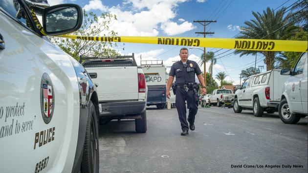 Los Angeles police investigate a fatal shooting and stabbing in North Hills Tuesday, March 29, 2016.