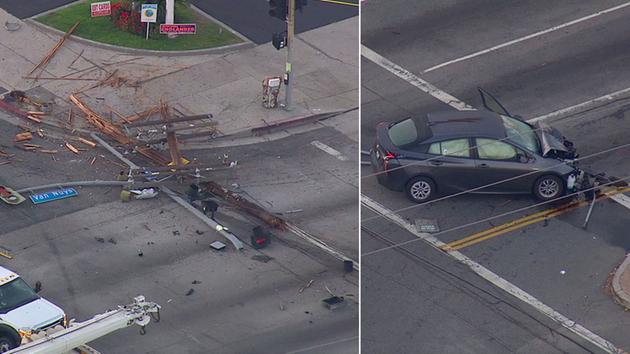 A mangled car and a shattered power pole are left along an intersection in Van Nuys. The crash caused a power outage on Friday, June 3, 2016.
