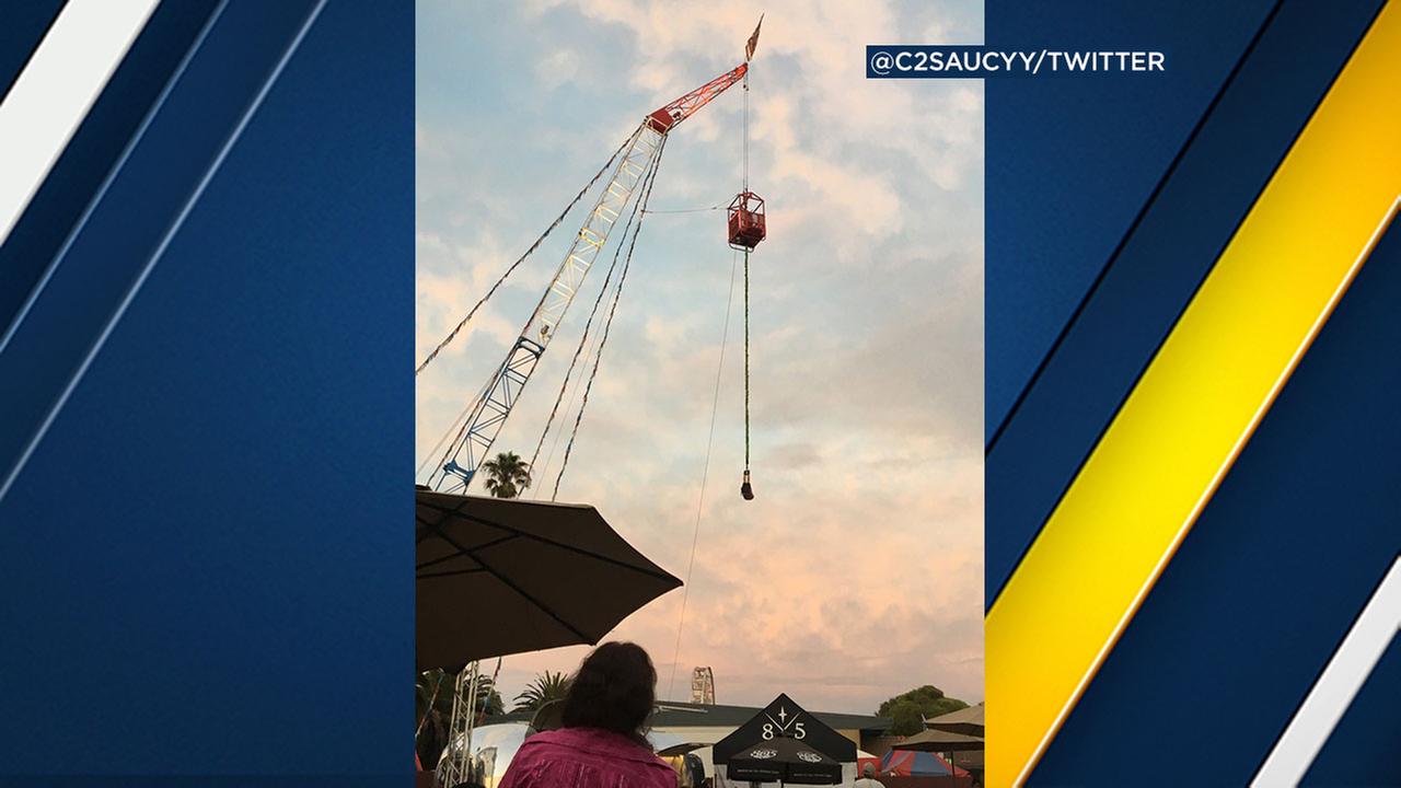 Three people, one upside-down, trapped on county fair ride Three people, one upside-down, trapped on county fair ride