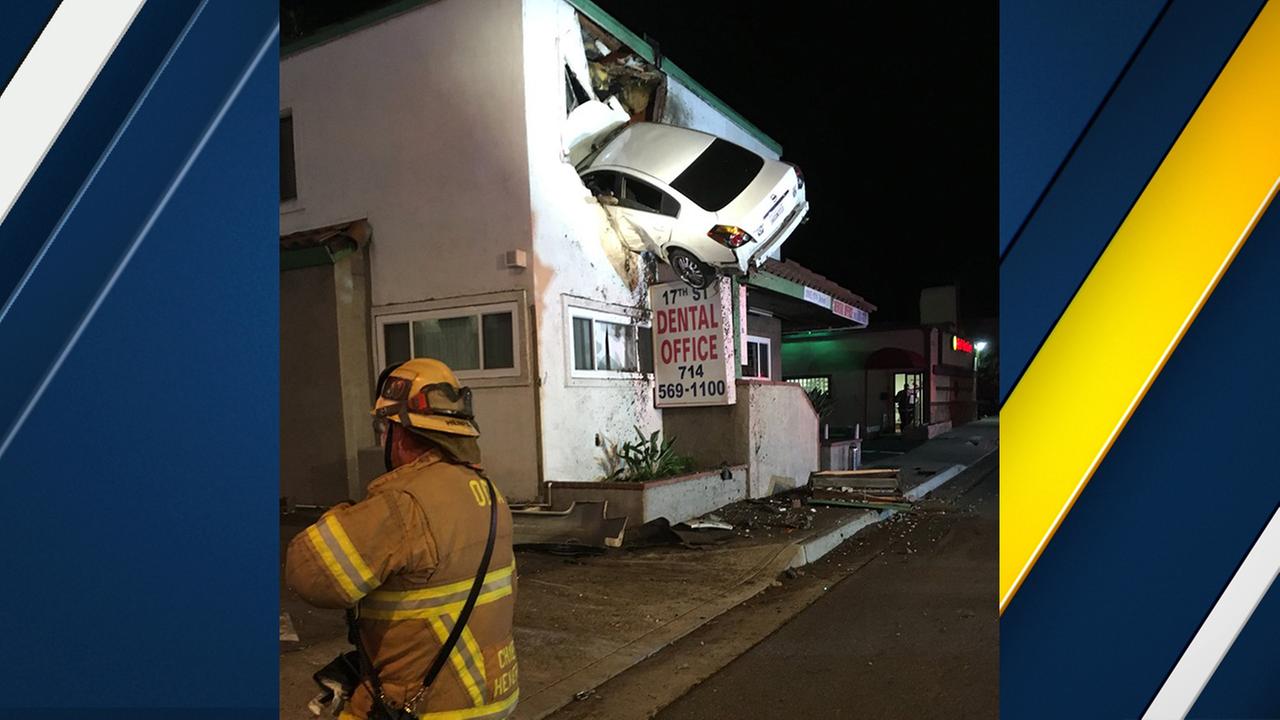 Car soars into second floor of Santa Ana building in bizarre crash; 2