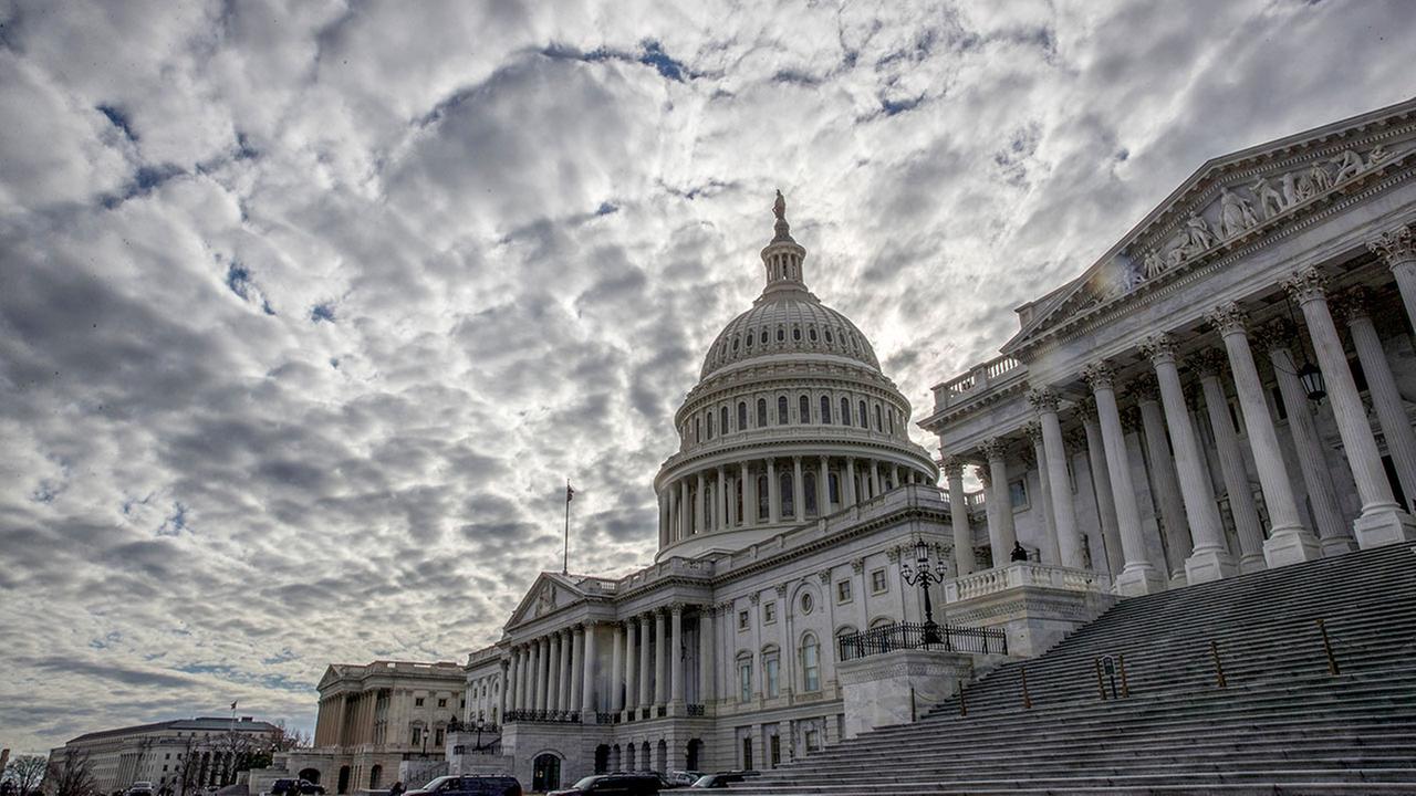 The Capitol is seen under cloudy skies on Day 2 of the federal shutdown, in Washington, Sunday, Jan. 21, 2018. 