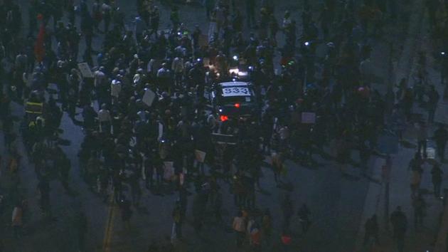 Ferguson protesters surround a police car on MLK Jr. Blvd near the 110 Freeway, Tuesday, Nov. 25, 2014. <span class=meta></span>