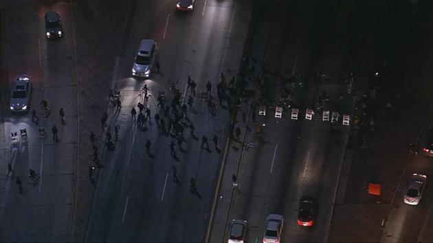 Protesters demonstrating after a grand jury decision not to indict Ferguson police officer Darren Wilson put up barriers on the 101 Freeway on Tuesday, Nov. 25, 2014.
