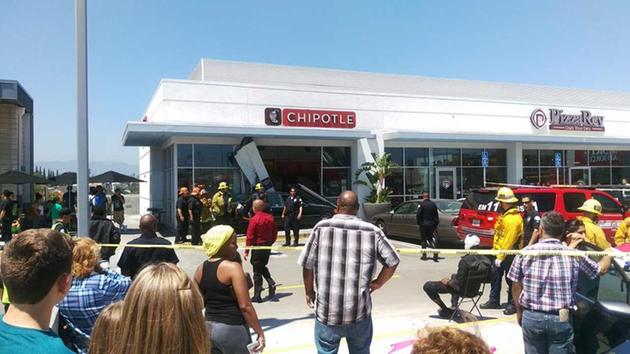 Firefighters respond to a crash at a Chipotle in the 4500 block of Pico Boulevard in the Mid-City area of Los Angeles Friday, June 19, 2015. 