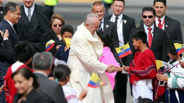 Pope Francis is greeted by children as well as Ecuadors President Rafael Correa upon his arrival to the Mariscal Sucre International airport in Quito, Ecuador on July 5, 2015.