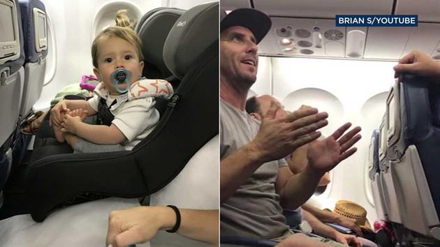 Brian Schear, right, is seen on a Delta flight, which he and his family members, including young son Grayson, left, were kicked off from following a dispute with the airline.