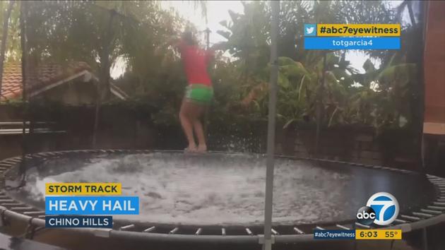 Some Southern Californians enjoyed the wild winter weather that hit on Sunday, with one person jumping around on her trampoline after the hail fell.