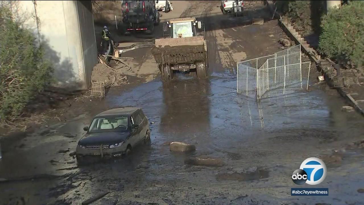A loader takes mud from the northbound lanes of the 101 Freeway, which remained covered in muck and mud in Montecito on Saturday, Jan. 13, 2018.
