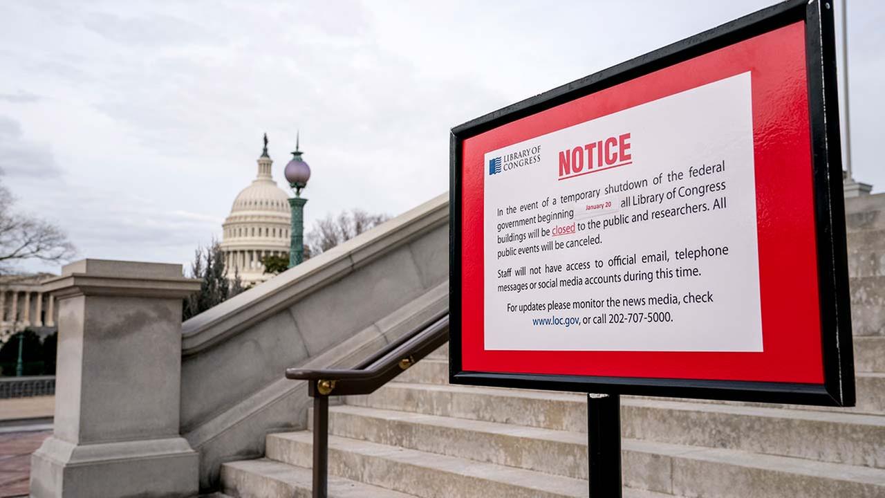The dome of the Capitol Building is visible behind a closure sign that is posted outside of the Library of Congress in Washington, Monday, Jan. 22, 2018. (AP Photo/Andrew Harnik)
