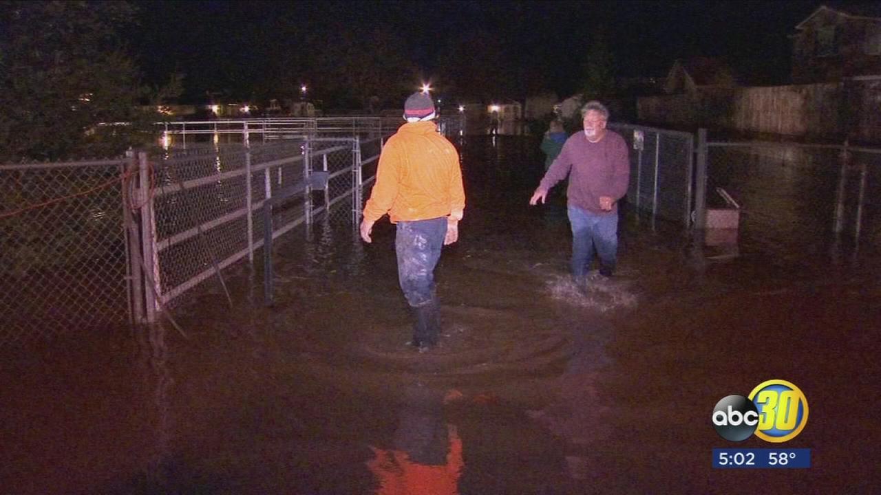 Properties flooded after canal spills over in Fresno County