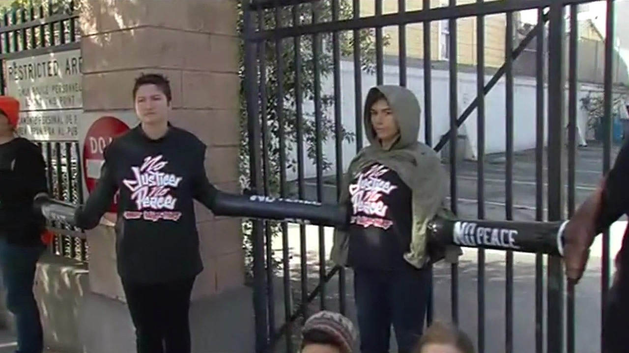 <div class='meta'><div class='origin-logo' data-origin='KGO'></div><span class='caption-text' data-credit=''>Several protesters chained themselves to the gates of the Mission District Police Station in San Francisco during the demonstration on Monday, March 23, 2015. (KGO-TV)</span></div>
