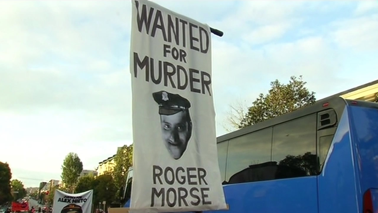 <div class='meta'><div class='origin-logo' data-origin='KGO'></div><span class='caption-text' data-credit=''>A poster of Officer Roger Morse, believed to be involved in the fatal shooting of Alex Nieto, held by protesters on Monday, March 23, 2015. (KGO-TV)</span></div>